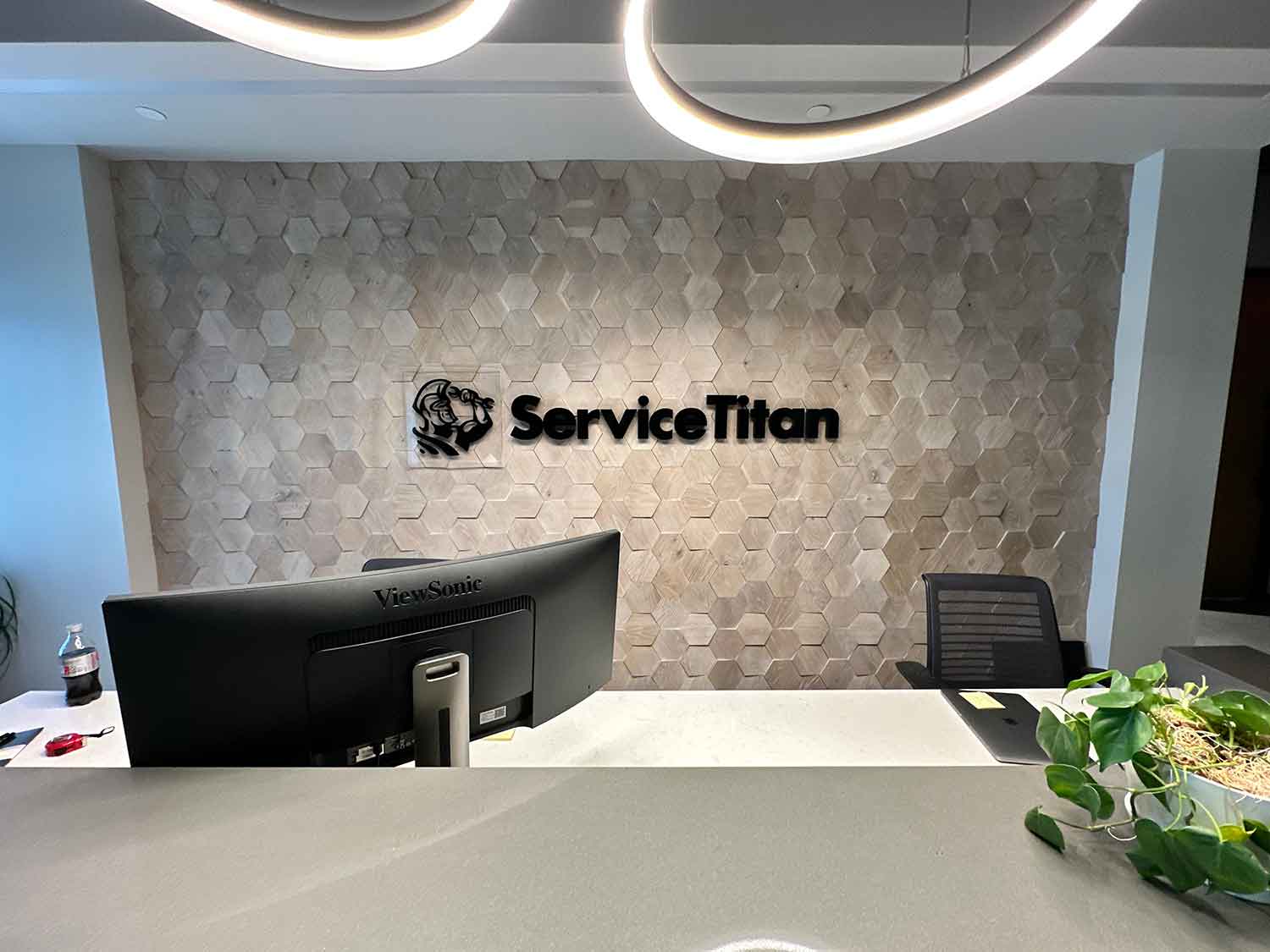 VisualPro created wall graphics and acrylic signage for Service Titan.
