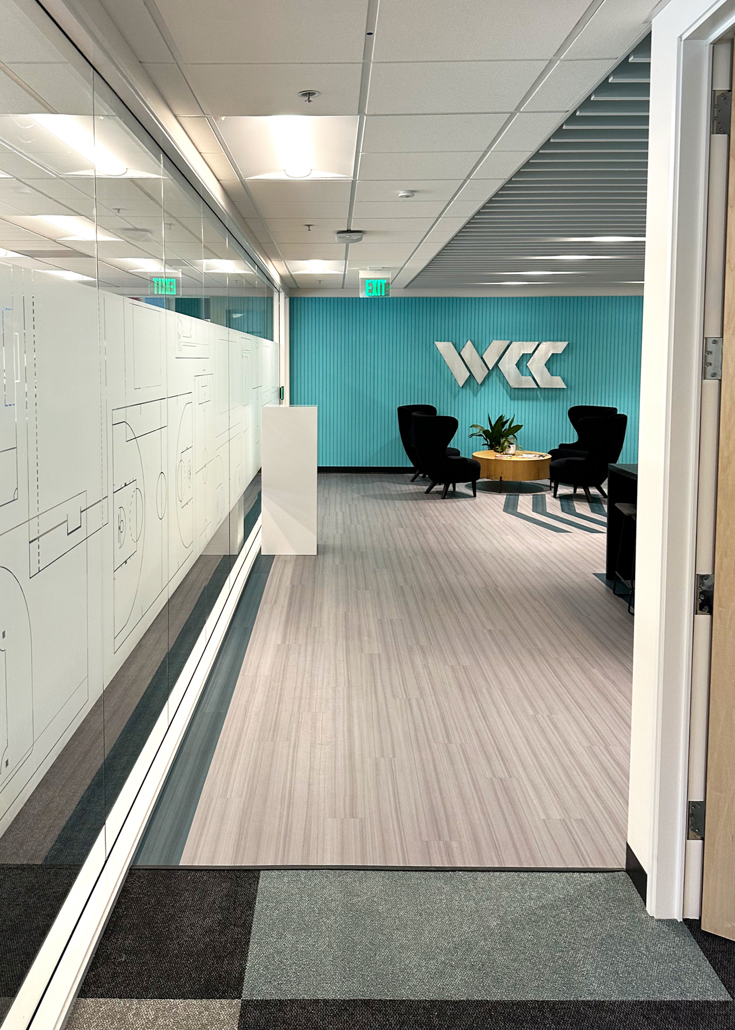 Combining custom window film and wall signage creates visual impact.